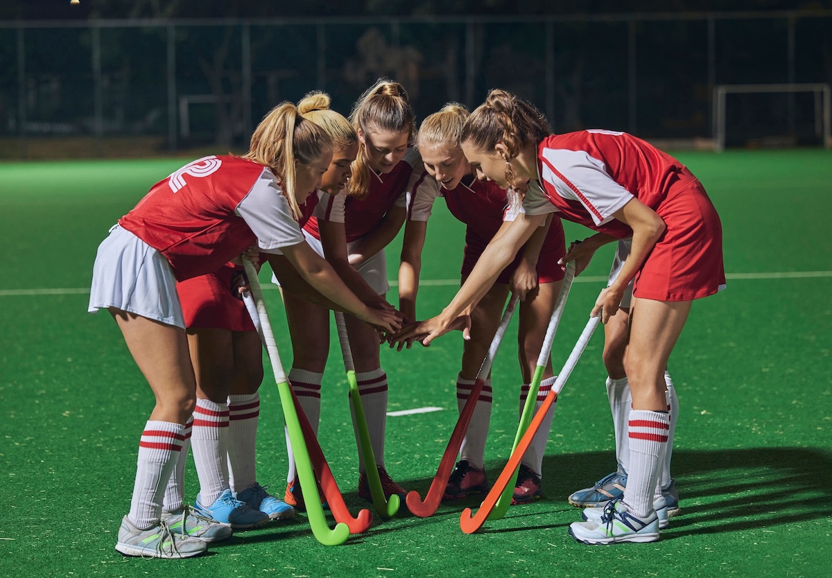 Field hockey players in a huddle