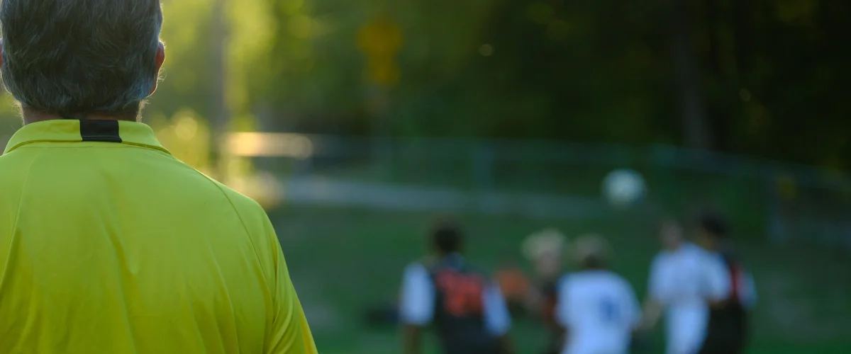 Referee in a green shirt