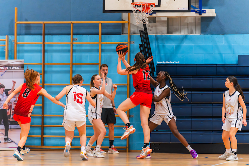 A basketball game where a player is shooting to score a shot.