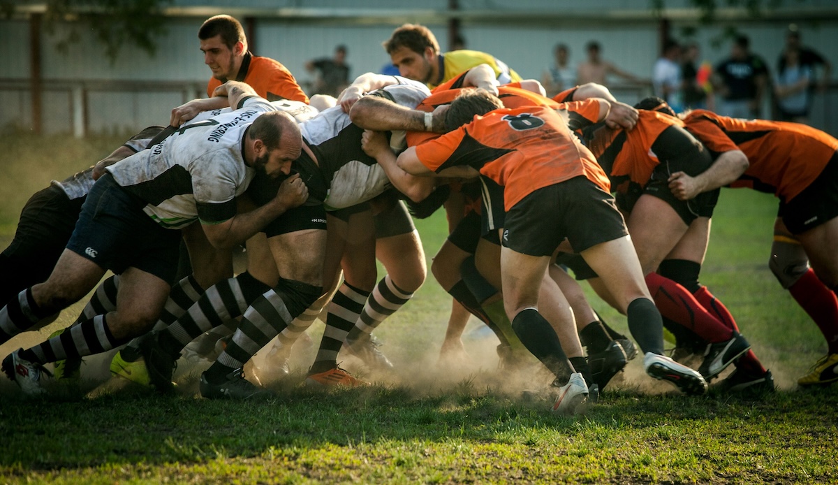 Two teams playing Rugby in a scrum.